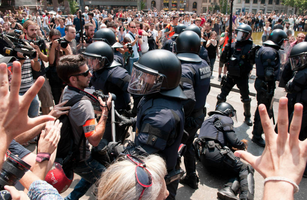 Barcelona, Spain. May 27, 2011. The police tried to remove the demonstrators from Plaça Catalunya, in Barcelona Spain. Thousands of people of the 15-M movement (Indignados) have been camping in the center of the city during the last two weeks, to protest against the financial crisis and the government's cuts for welfare . Finally the demonstrators managed to stay.