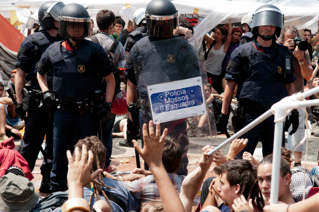 Barcelona, Spain. May 27, 2011. The police tried to remove the demonstrators from Plaça Catalunya, in Barcelona Spain. Thousands of people of the 15-M movement (Indignados) have been camping in the center of the city during the last two weeks, to protest against the financial crisis and the government's cuts for welfare . Finally the demonstrators managed to stay.